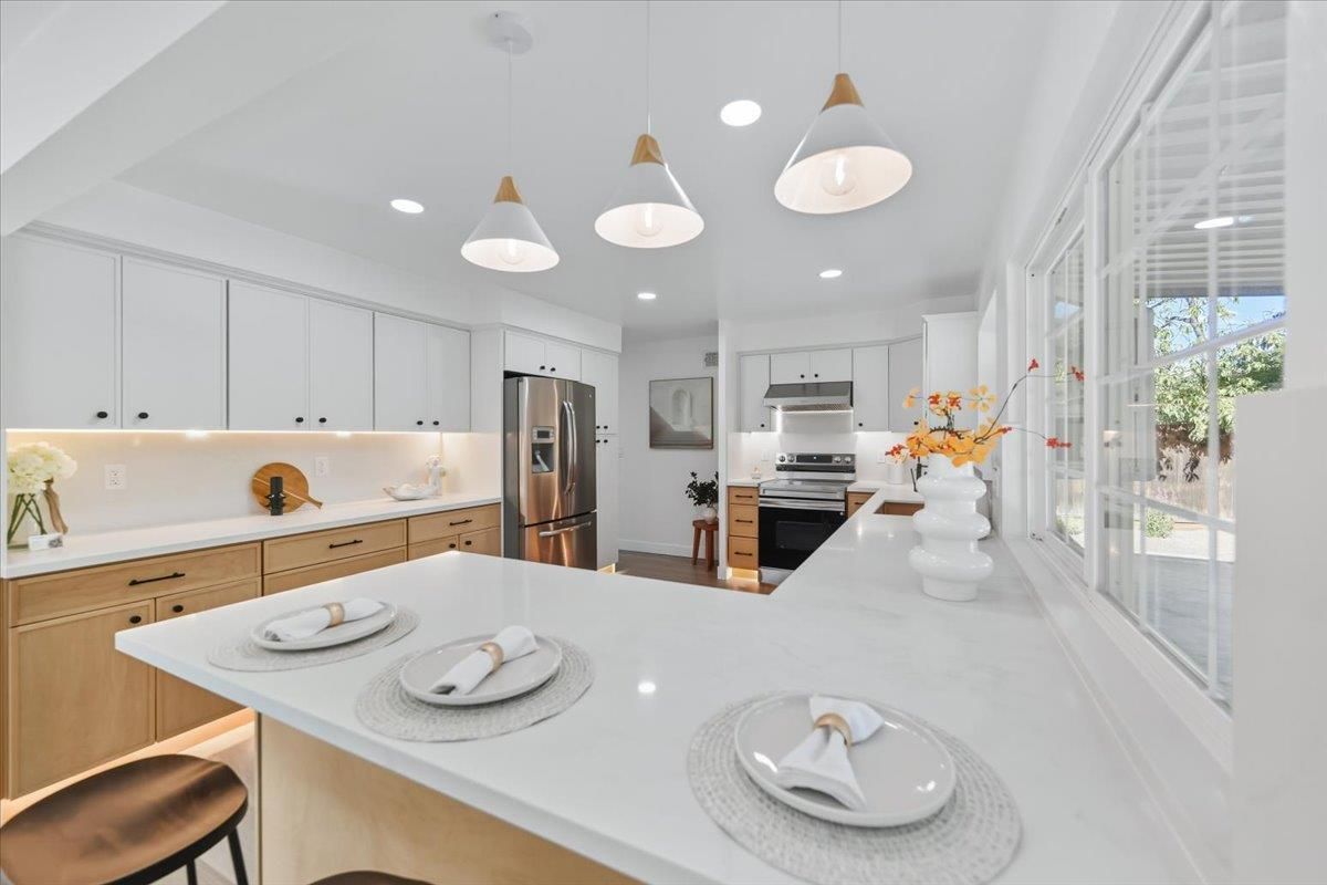 White quartz kitchen with pendant lights