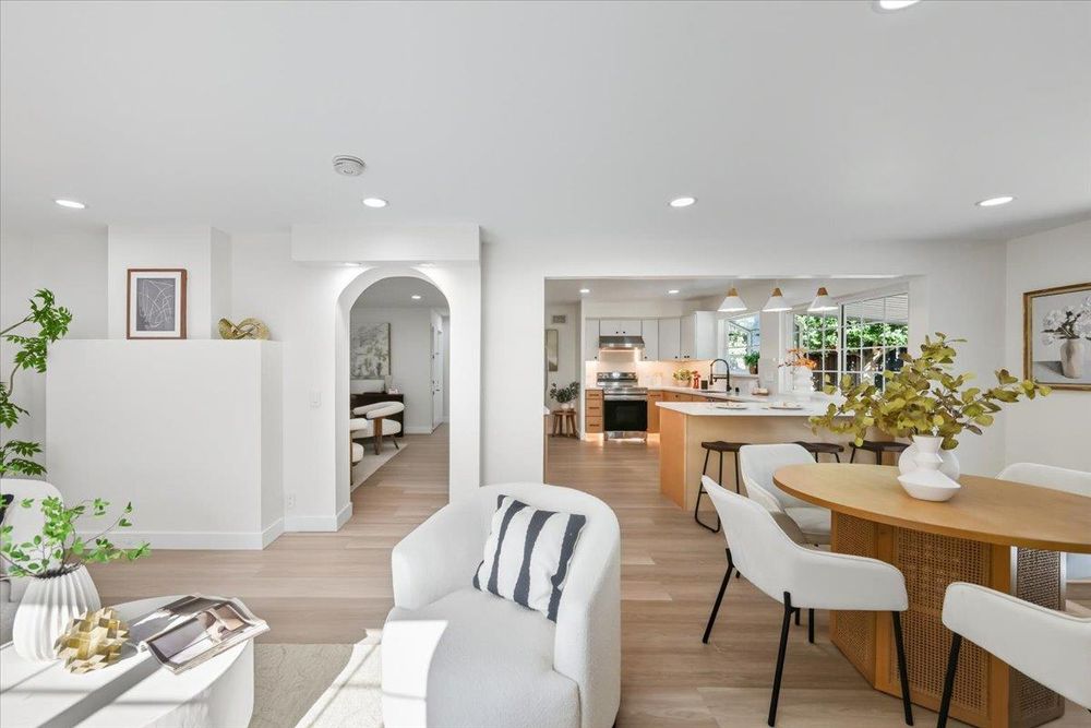 Open living and dining with arched entry