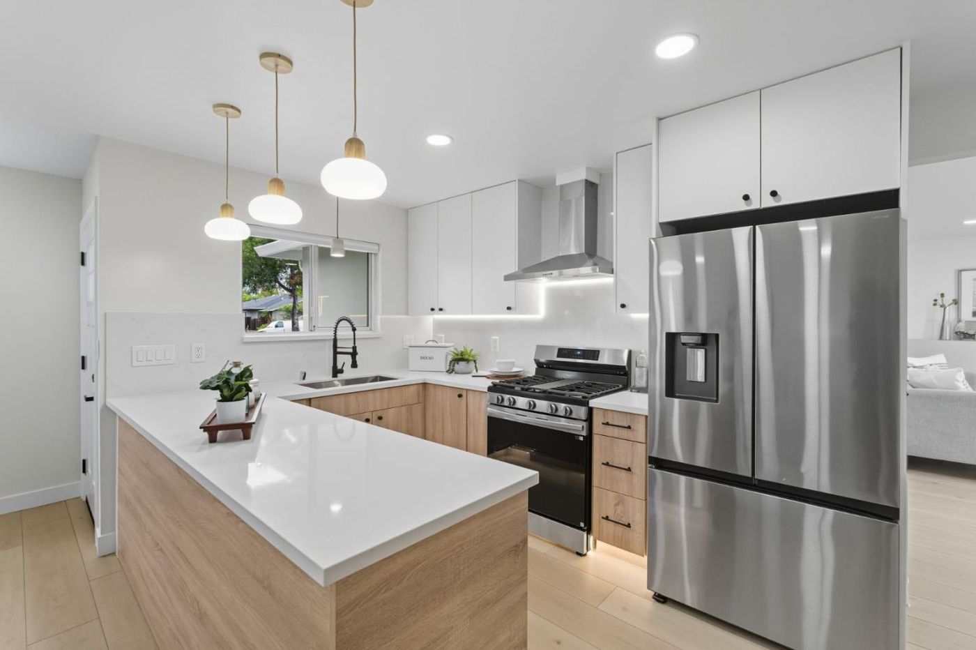 Kitchen with pendants and stainless appliances